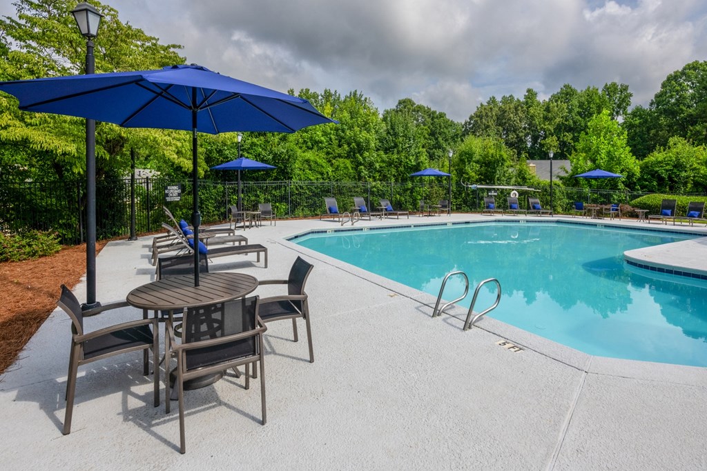 Resort-style pool area featuring comfortable lounge chairs at Forest Glen apartments in Austell, GA 30106, near South Cobb County and Douglasville.