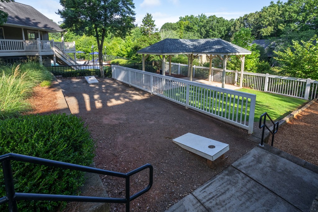 Outdoor recreational area with cornhole game at Forest Glen apartments in Austell, GA 30106, near South Cobb County and Douglasville