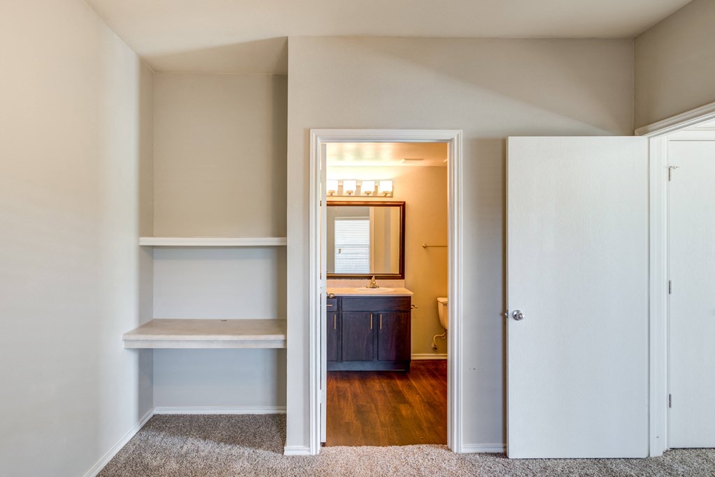 bookshelf and bathroom located in bedroom