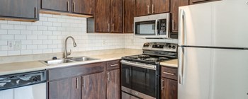 dark wood kitchen with stainless steel appliances - Photo Gallery 19