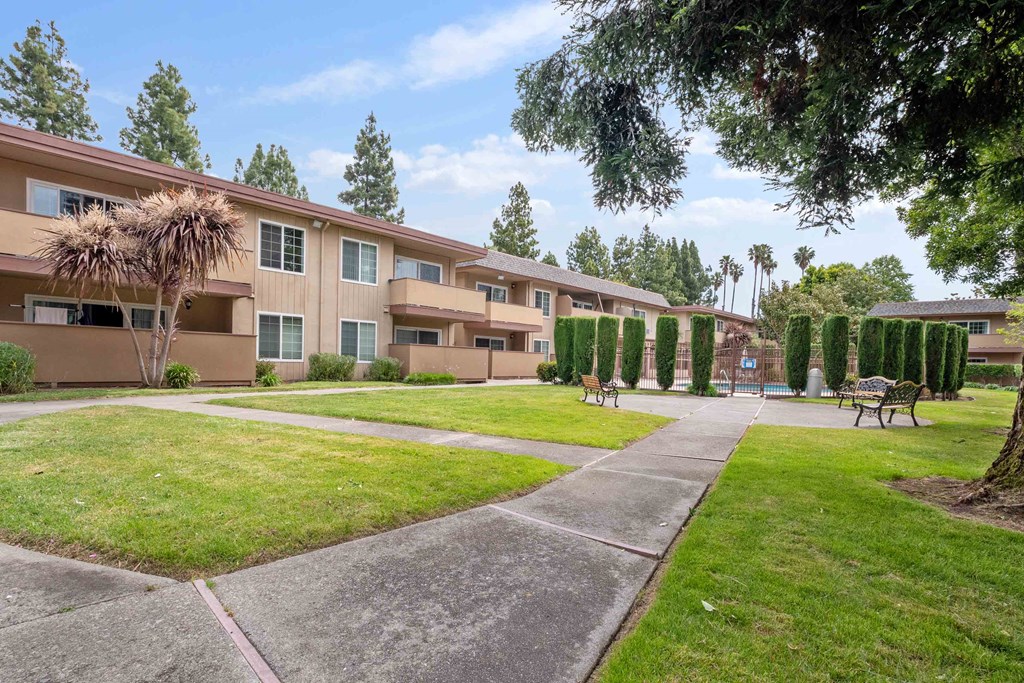 our apartments offer a walkway to the pool and a lawn