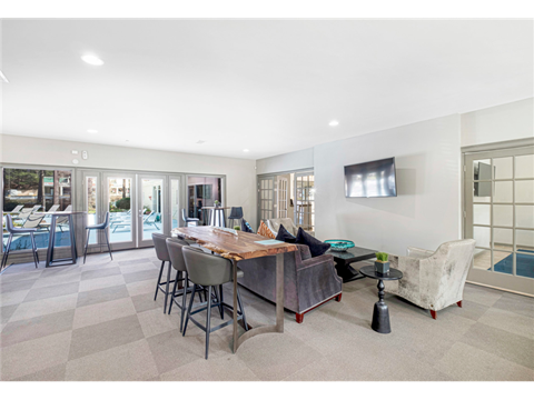 a living room with a couch and a table with chairs