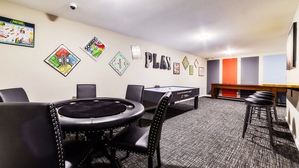 a game room with a table and chairs and a pool table