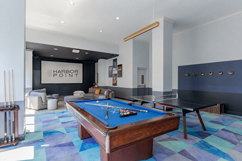 A pool table in a room with a sign that says Harbor Point.