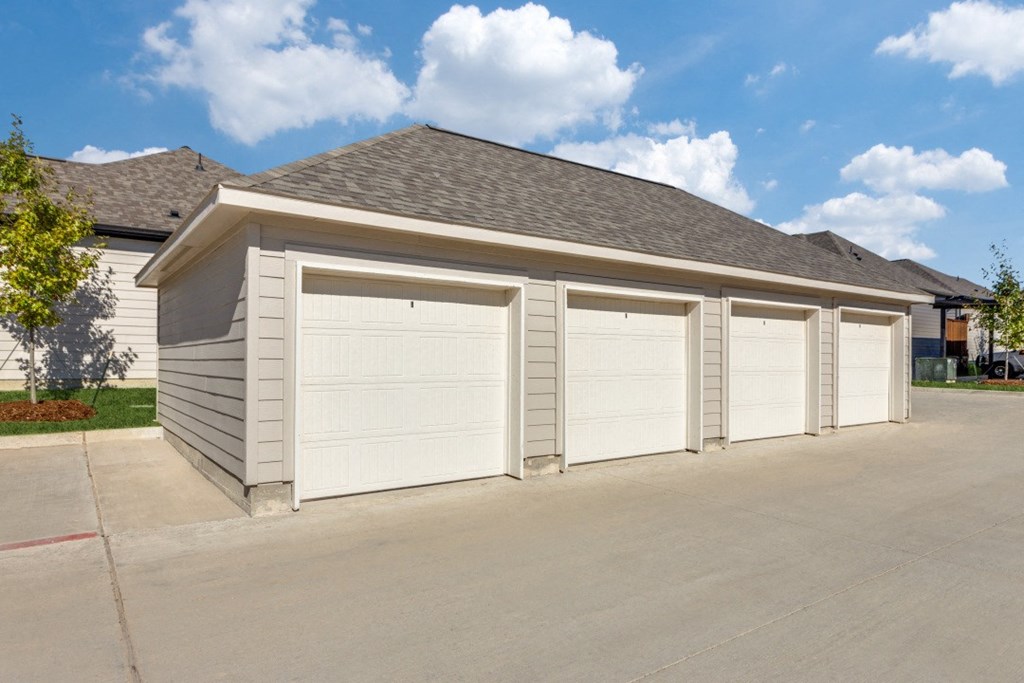 a garage with three garages on the side of a house