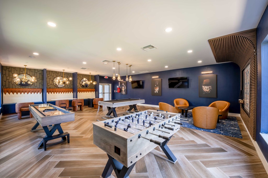 Gatehouse on the Green Apartments in Plantation, FL photo of a game room with a foosball table and tables