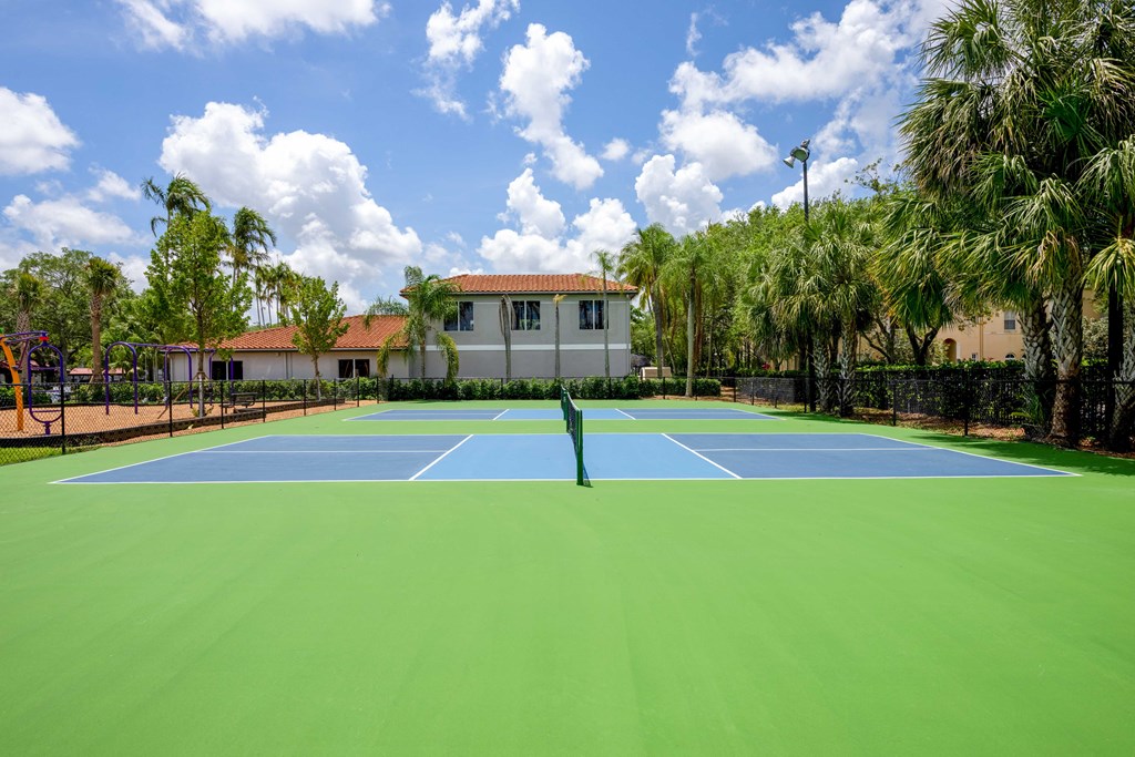 Gatehouse on the Green Apartments in Plantation, FL photo of a tennis court with palm trees