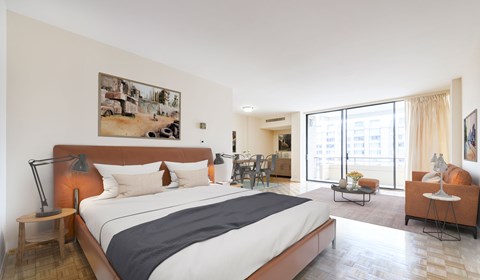 A bedroom with a large bed and a painting on the wall.