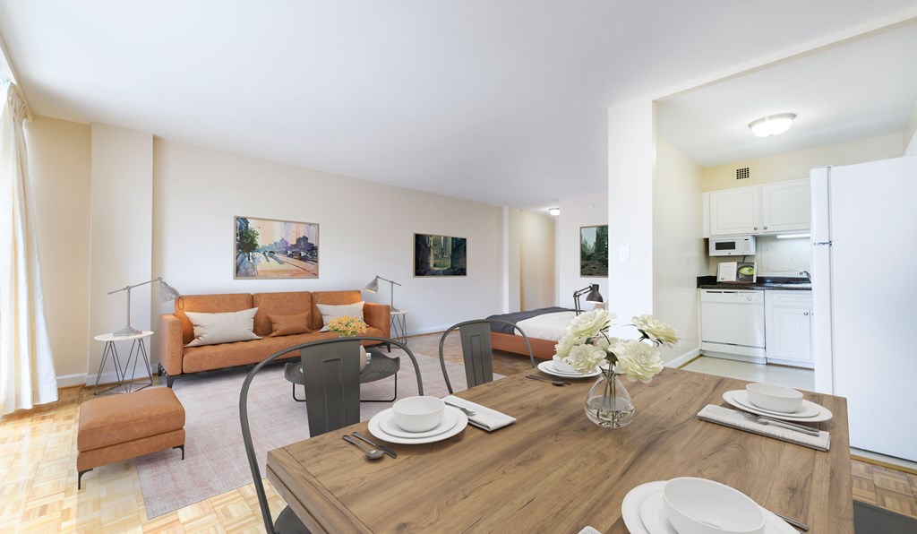 A dining table with plates and glasses on it in a well lit room.