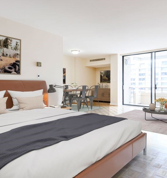 A bedroom with a large bed and a balcony.