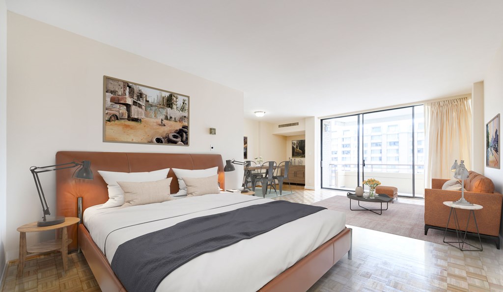 A bedroom with a large bed and a painting on the wall.