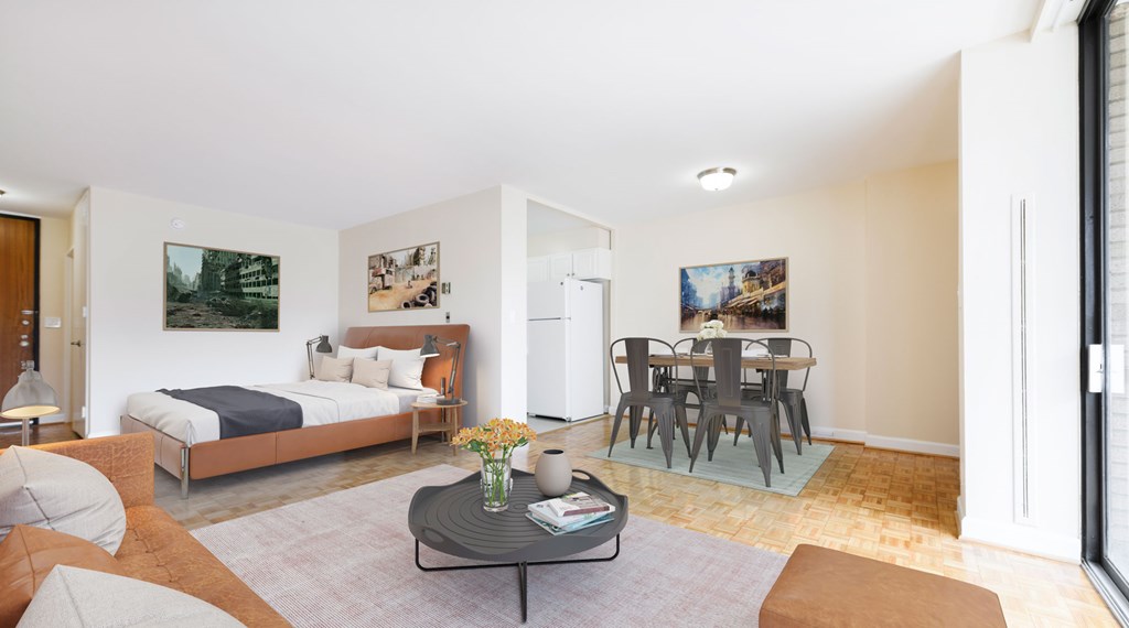 A living room with a couch, a coffee table, and a dining table.