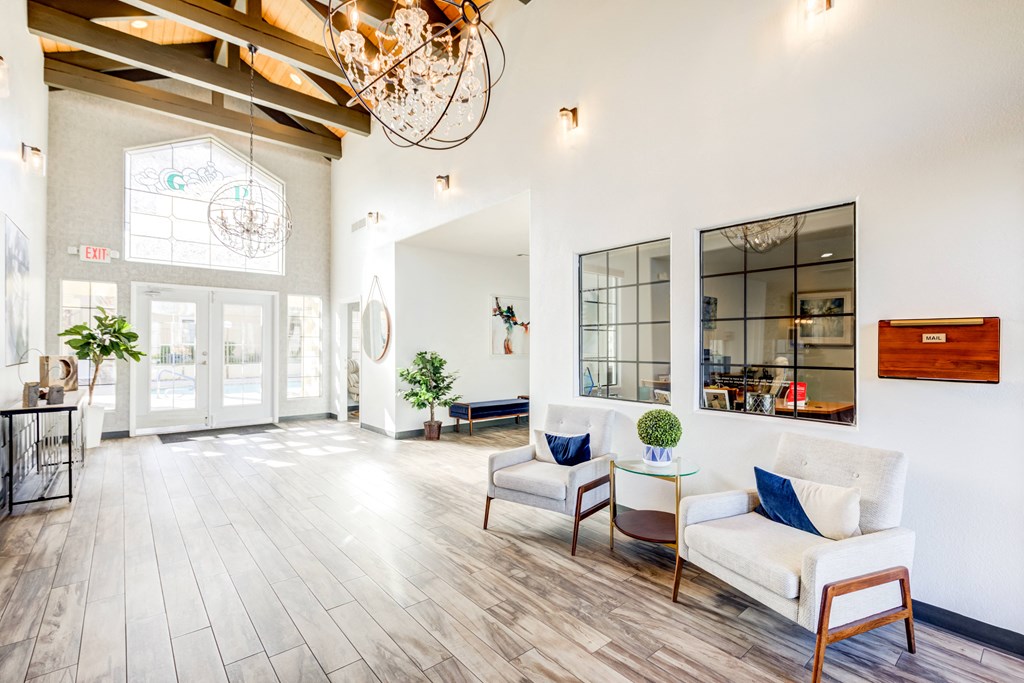 a living room with white furniture and a chandelier
