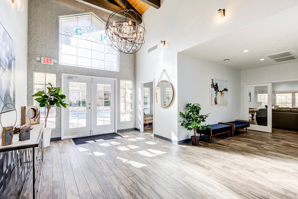 a large lobby with white walls and doors and a large chandelier
