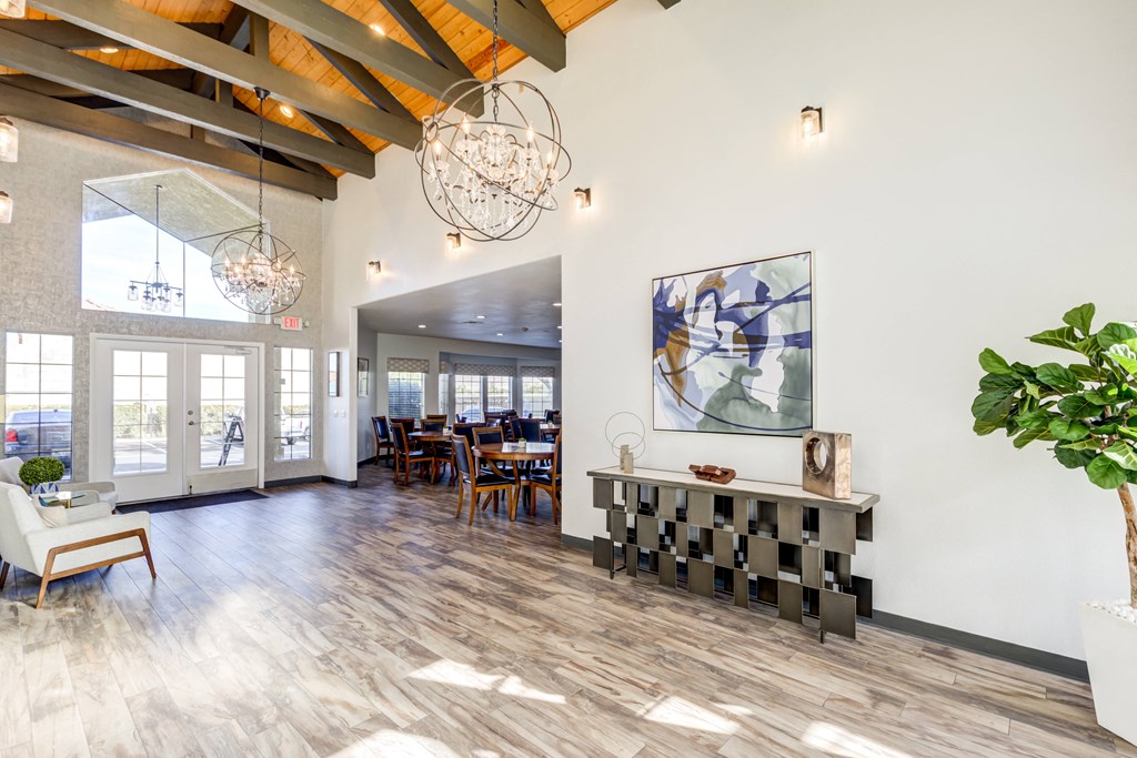 a dining room with a table and chairs and a large window