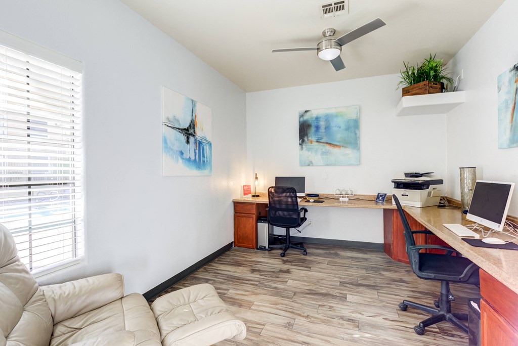 an office with a couch and a desk with a computer