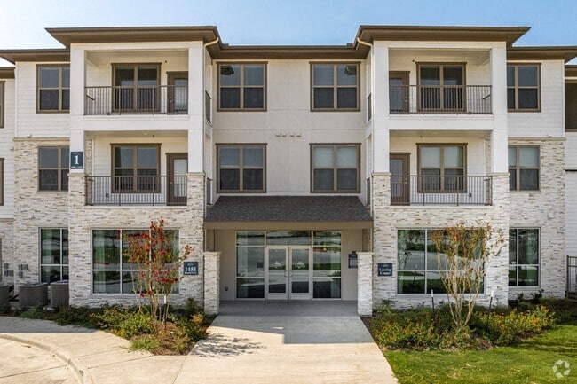a large building with a sidewalk in front of it
