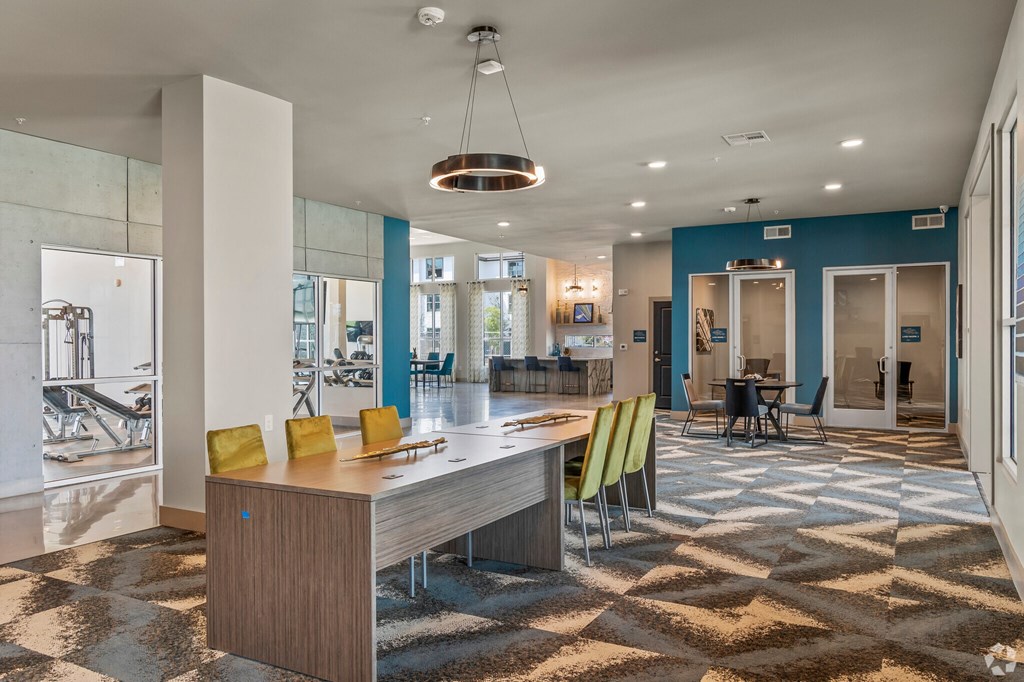 a conference room with a long wooden table and yellow chairs