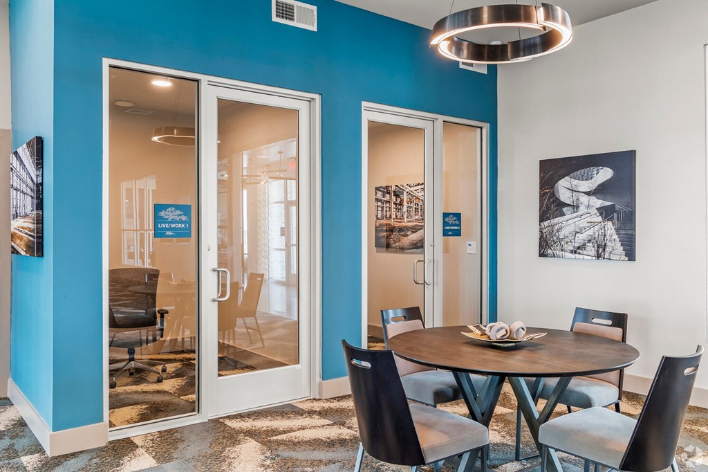a dining room with blue walls and a table and chairs