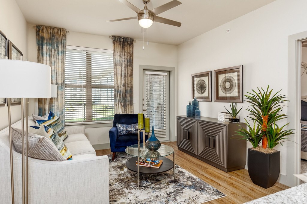 an open living room with a ceiling fan and a window