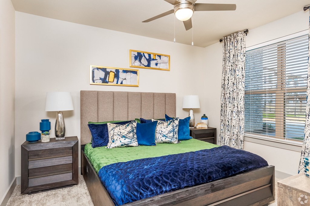 a bedroom with a bed and a ceiling fan