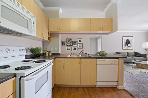 a kitchen with white appliances and wooden cabinets