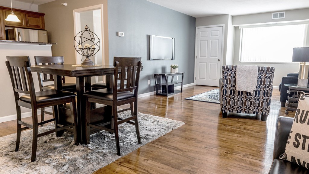 a dining room and living room with a table and chairs