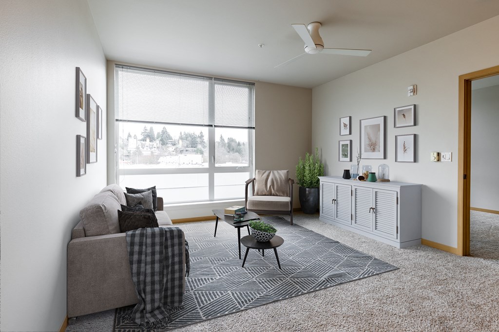 a living room with a large window and a couch