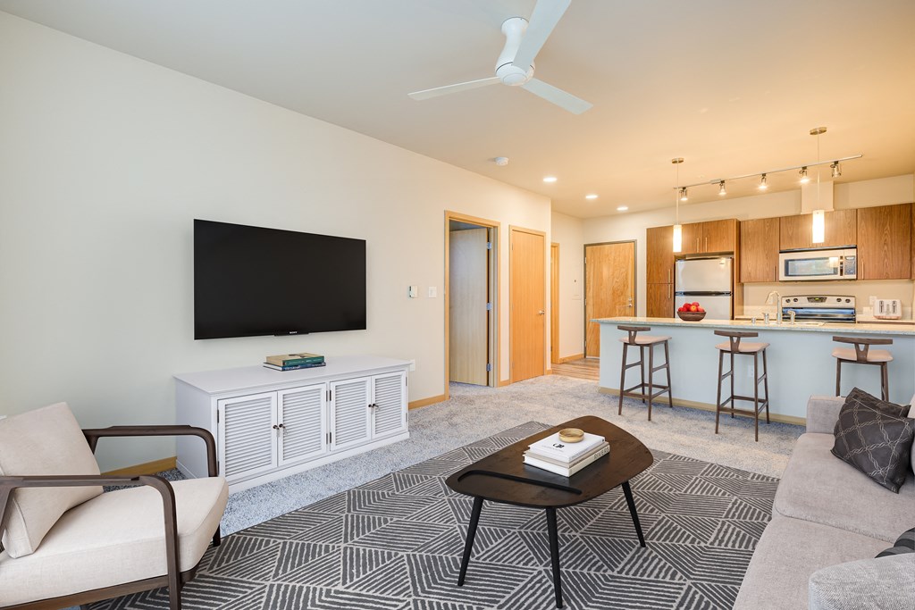 a living room with a couch and a table with a television
