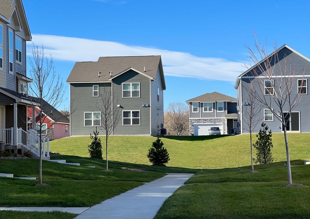 Green walking paths between home and townhome rentals at Avery Park
