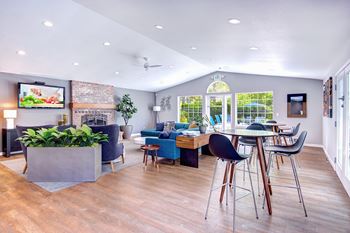 a living room and dining room with a fireplace and a tv on the wall