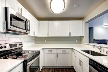 renovated unit kitchen featuring white cabinets, - Photo Gallery 4