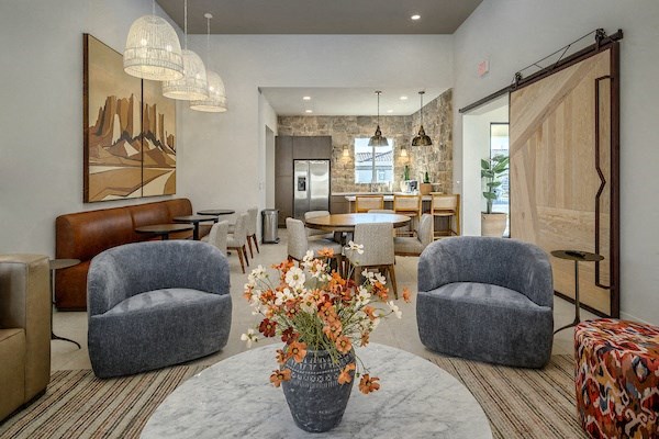 a living room and dining room with chairs and a table