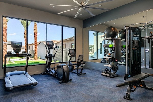 a workout room with a view of the fitness center and windows