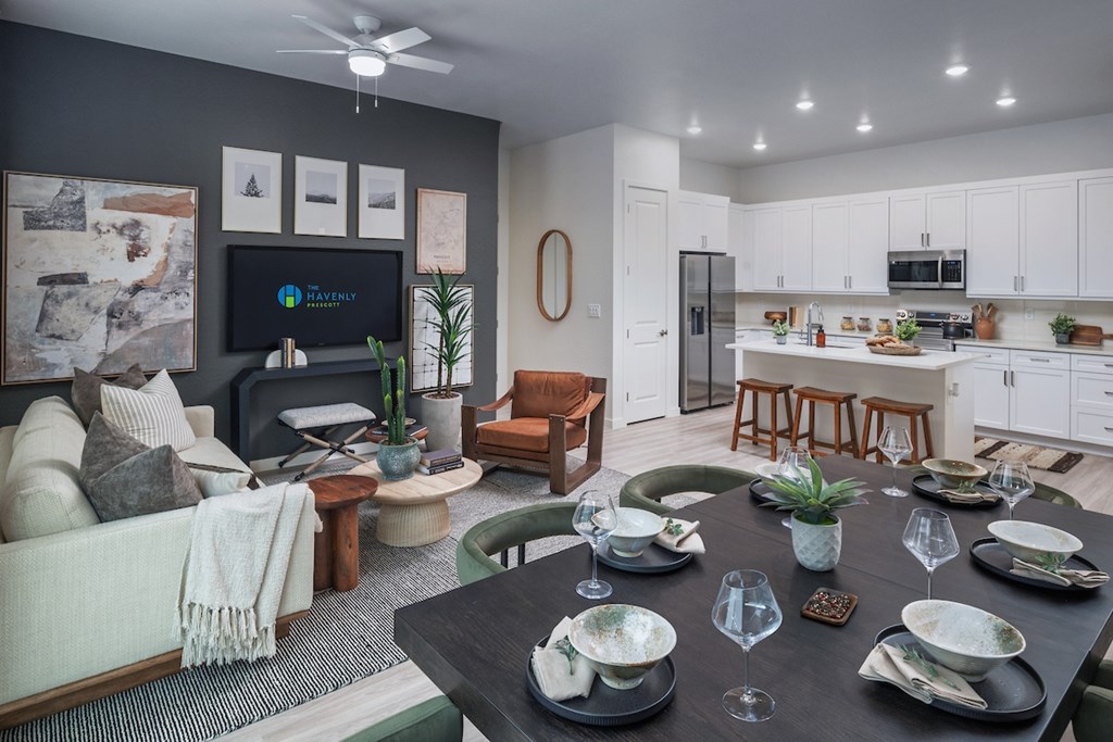 A modern dining room with a black table set for six.