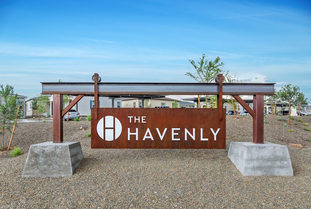 A sign that says "The Havenly" is in front of a building.
