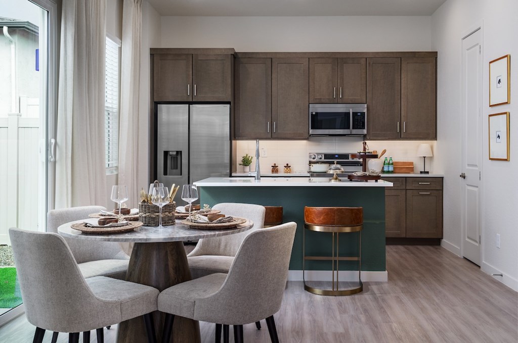 A kitchen with a table set for four.