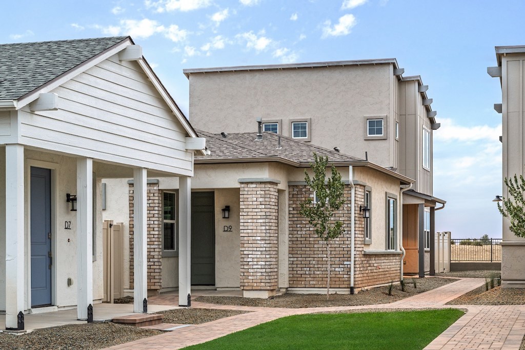 A row of houses with a blue sky in the background.