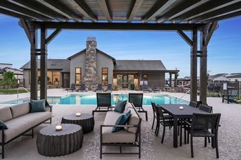 A modern outdoor living space with a pool and furniture.