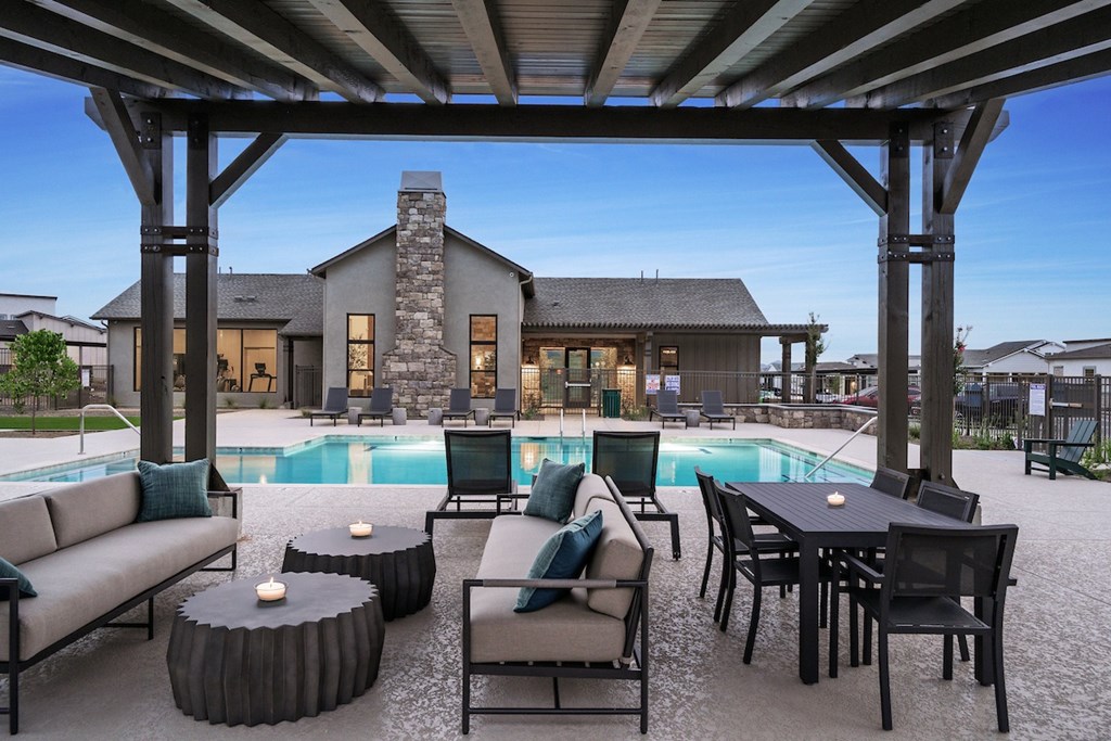 A modern outdoor living space with a pool and furniture.