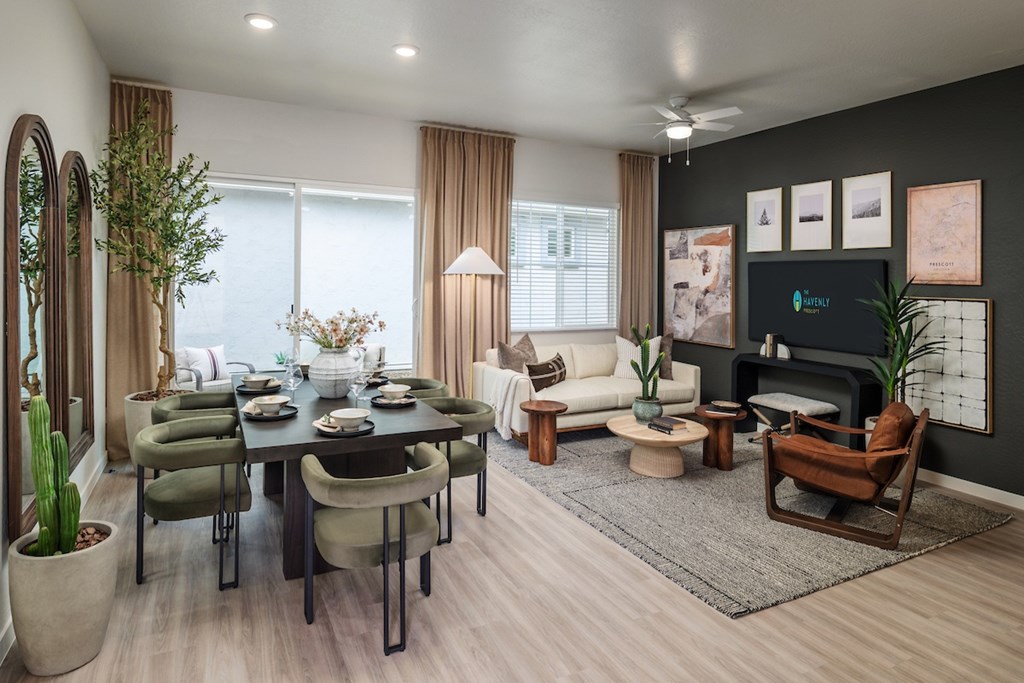 A modern living room with a dining table set for six.