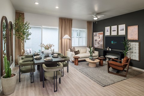 A modern living room with a dining table set for six.