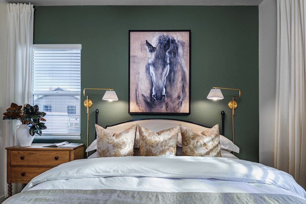 A bedroom with a large painting of a horse on the wall.