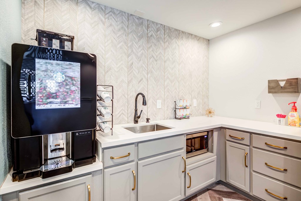 a large kitchen with white cabinets and a sink