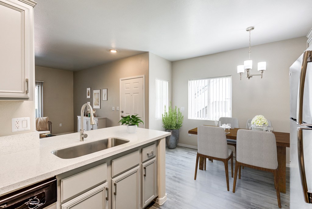 an open kitchen and dining room with a table and chairs