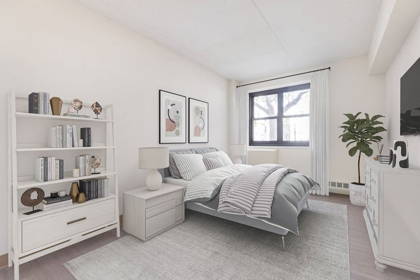 a white bedroom with a bed and a window