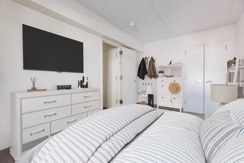 a bedroom with a bed and a tv
