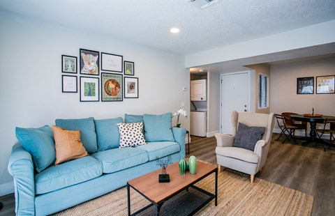 Bright apartment living room with wood-style flooring at Haven at Lone Mountain in Las Vegas