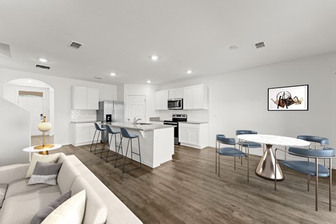 A modern kitchen with a dining table and chairs.
