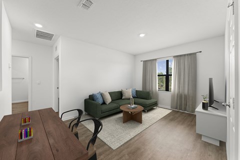 A living room with a green couch and a wooden coffee table.